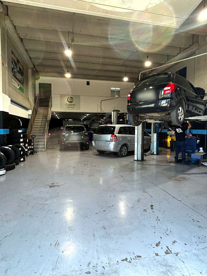 Inside the garage, with cars and lifts